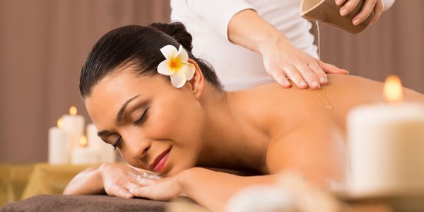 Woman having a back massage with therapeutic oil