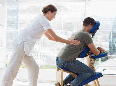 Massage therapist giving an onsite chair massage