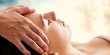 Therapist giving client craniosacral therapy