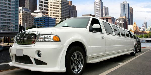 alt="white suv limo diver side view"