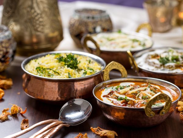 Traditional spicy Indian dish served in copper dishes