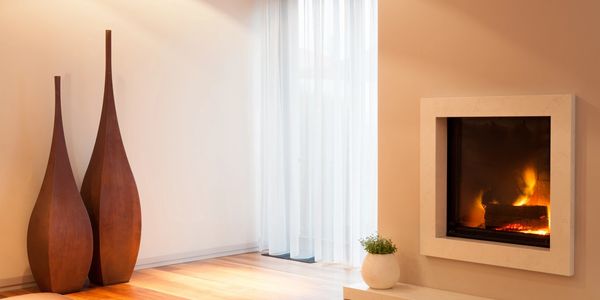 light shining through a white curtain into a room with a indoor inbuilt fireplace