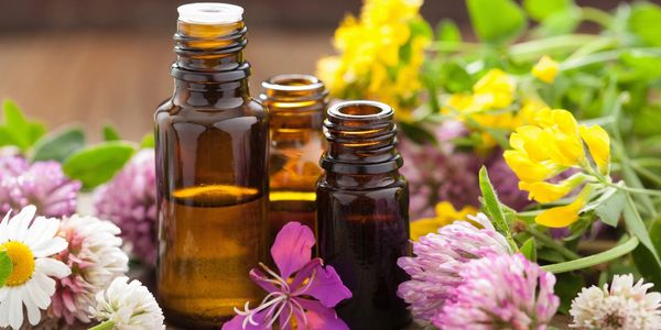 Essential oil bottles and flowers