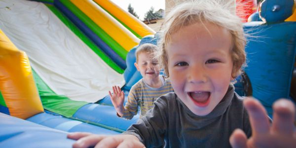 children playing on bounce house
