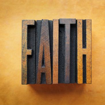 A woodblock of the word "Faith"