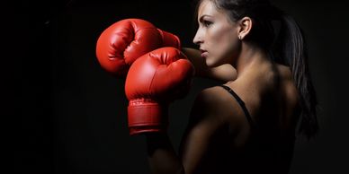 Self Love Diva coach profile of woman with red boxing gloves