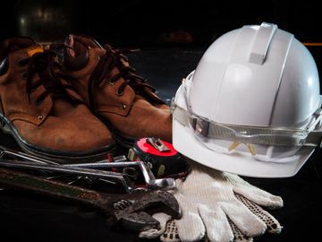 Work boots, hard hat and tools