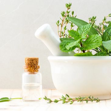 Herbs and oils in a mortar and pestle