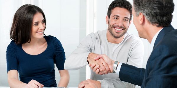 Insurance customers shaking hands with an agent