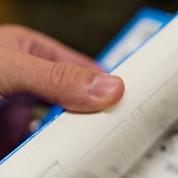 Close up color photo of a hand opening a book