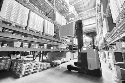 Pallet of Cartons being forklifted onto a pallet rack in a storage warehouse.