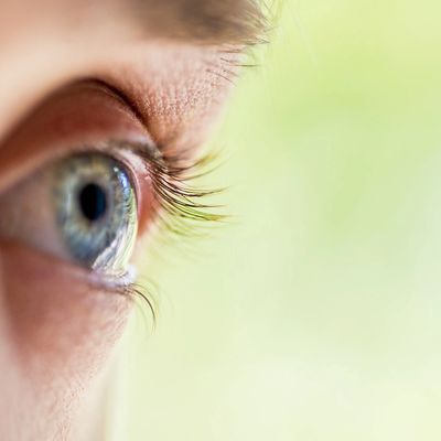 Close-up eye of man watching his partner having sex with someone else