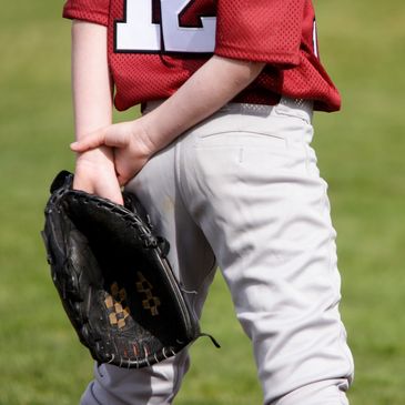 A kid with a black baseball mitt.