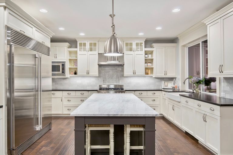 Beautifully painted kitchen cabinets, The grey island is in style.