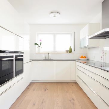 Redesigned kitchen white wood floors and white cabinets