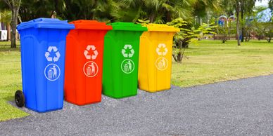 Blue, red, green and yellow garbage boxes placed in line


