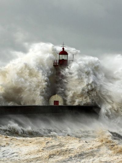 Counselling and life can feel like weathering the storm. Image of a light house and stormy seas