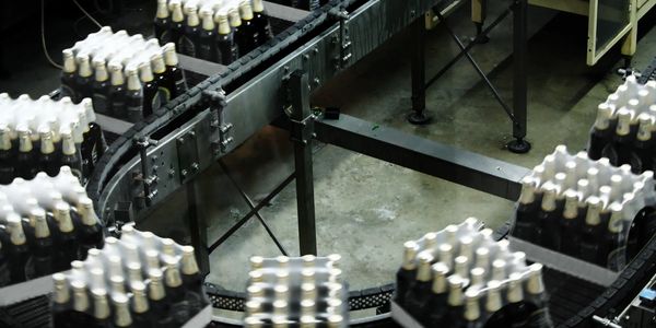 A production line with cases of beer moving along.