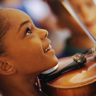 child playing her violin and is flourishing with her talent.