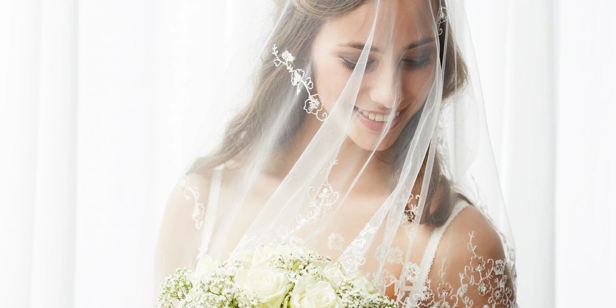 A bride in her wedding dress and veil.