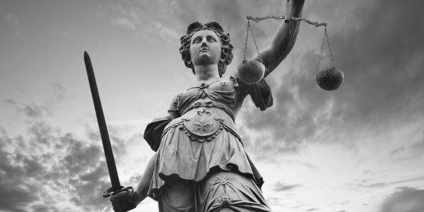 Athena statute.  Balancing the scales and a sword.  Legal representation of a fair fight.