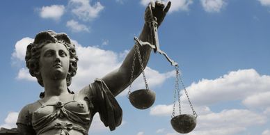 Picture of Lady Justice holding scales of justice