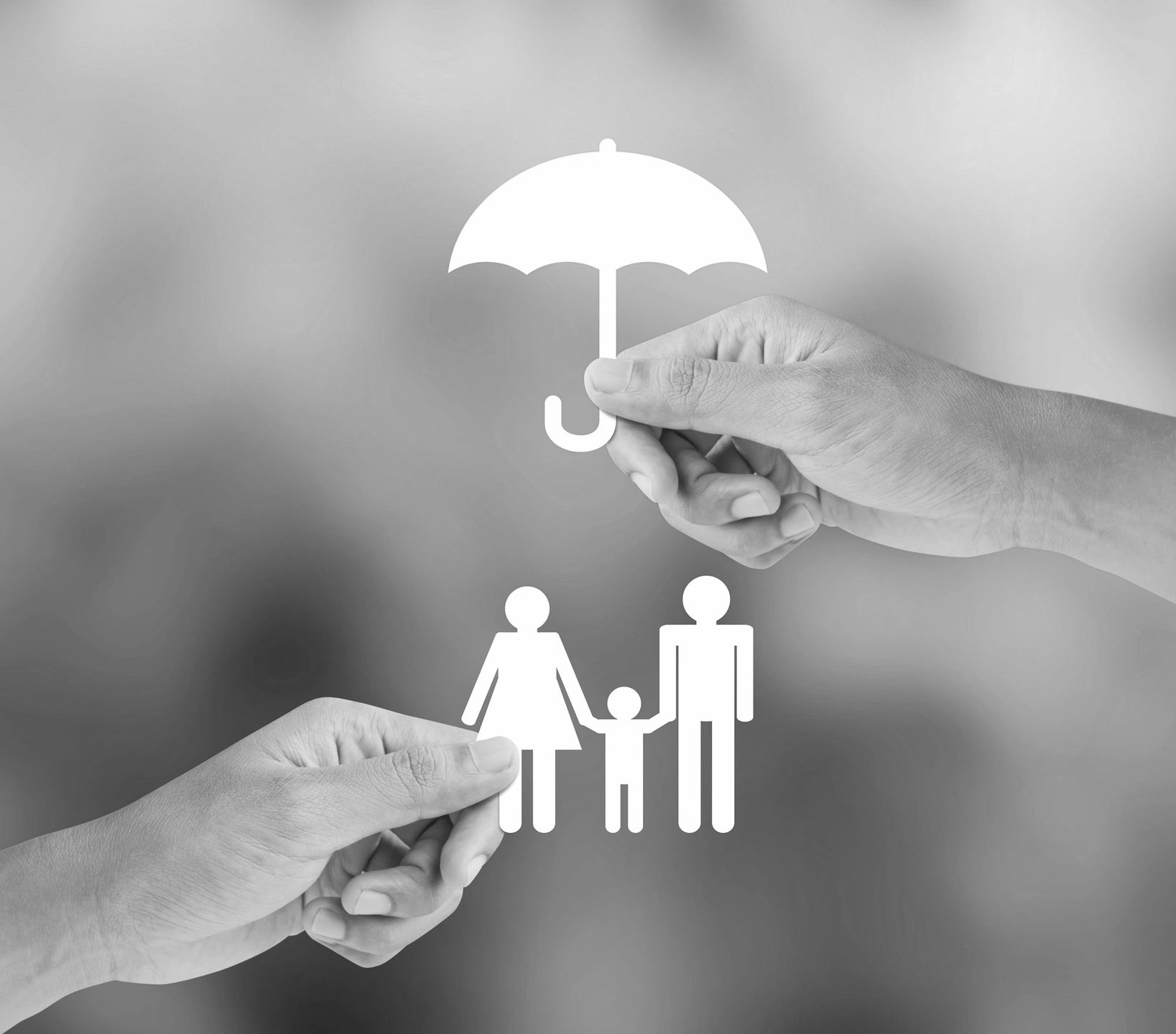 White umbrella held over family icon by hands.