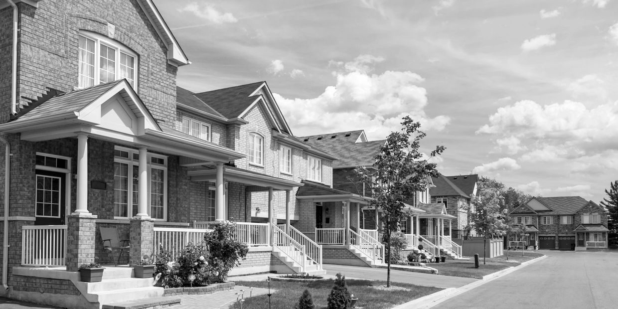 A row of town homes in a planned community with well manicured landscaping representing rental homes