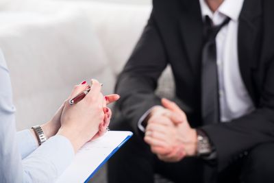 Couple speaking in mediation showing hands only