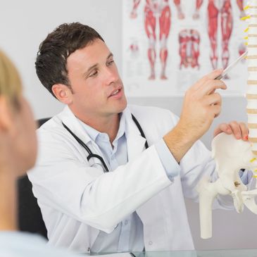 chiropractor teaching his patient about the nervous system and the spine