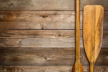 Red Oar Writing paddles on wood background