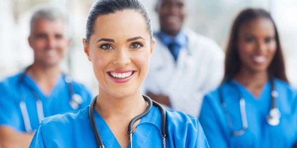 Nurses and Doctors wearing stethoscopes and smiling 