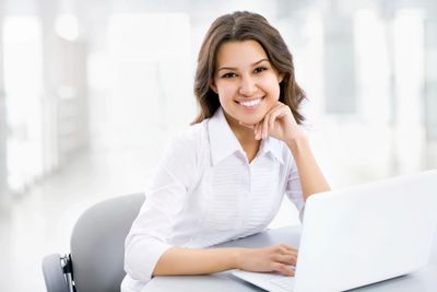 beautiful lady sitting at computer at Super Dermatology office