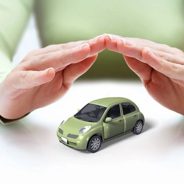 A pair of hands making a dome over a toy car