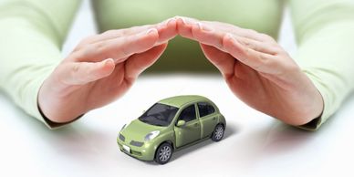 Hands covering car, auto insurance concep
