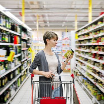 women food shopping and reading food label