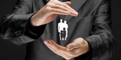 Hands wrapped around symbol of family, personal insurance coverage concep