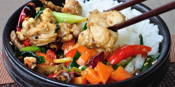 bowl of rice with vegetables and chicken