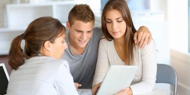 Young couple looking at financing options with representative 