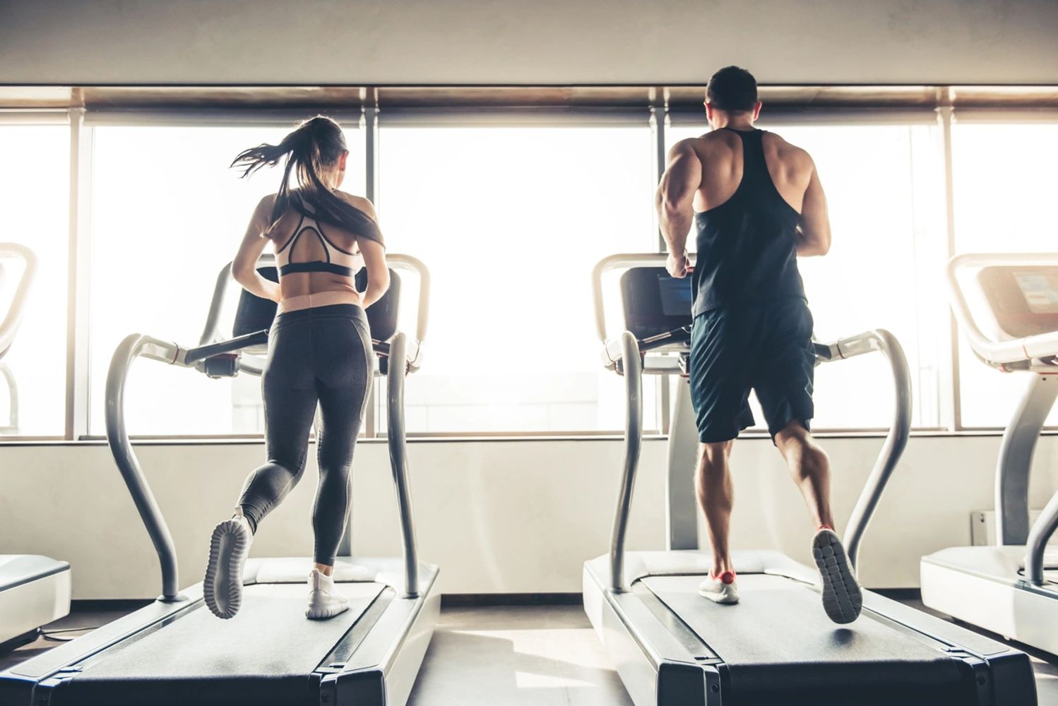 Two people on treadmills