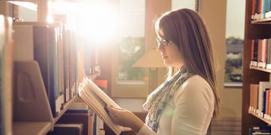 Woman reading a book about breast augmentation and other breast enhancement procedures