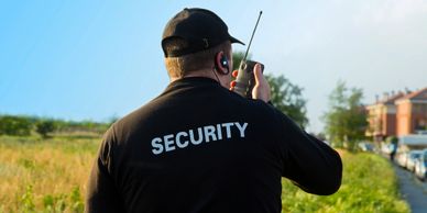 a security guard radioing in a report
