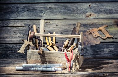 Photo of a tool box with well worn and used carpenter hand tools.