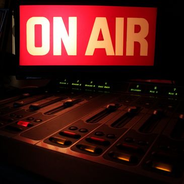 On Air sign lit up in a radio station studio where jingles and voice-overs are heard during commercial breaks.