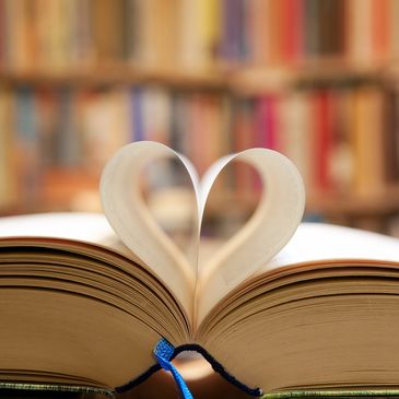 Book open with pages forming a heart