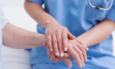 DPC doctor holding patient's hand