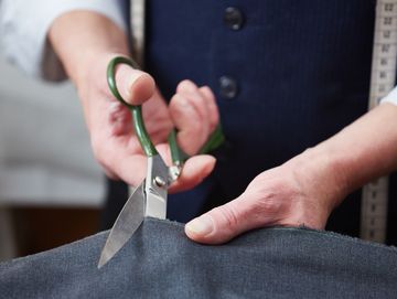 man cutting fabric