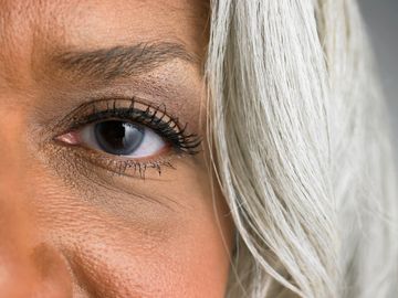 Partial of woman's face showing her eye and silver white hair