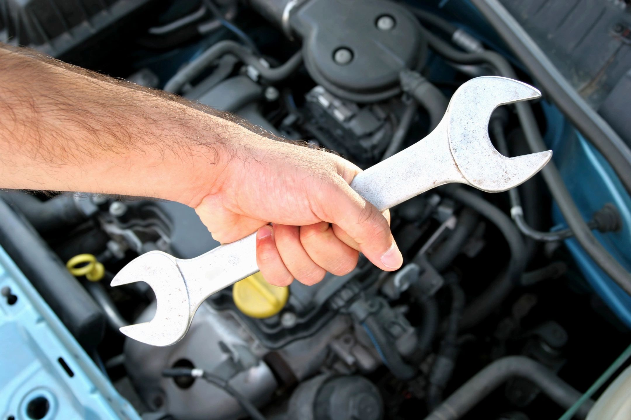 auto mechanic holding wrench. diesel mechanic holding wrench. vehicle mechanic holding wrench.