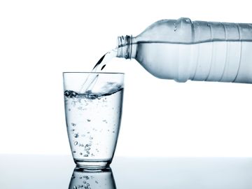 Water bottle filling a glass